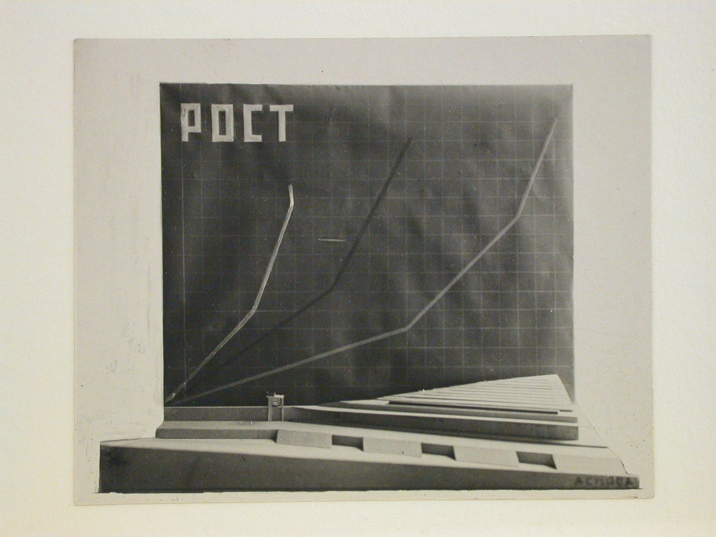 Photograph of a side elevation of a model for a Palace of Soviets showing a chart titled "ROST" [GROWTH], Moscow