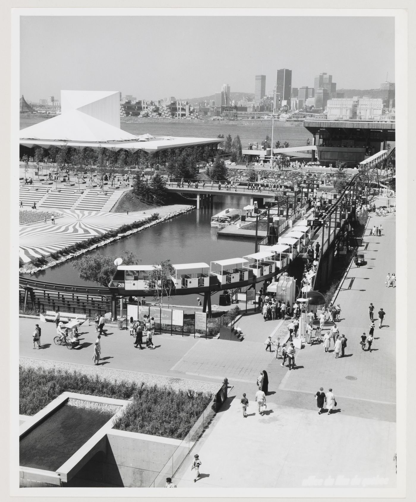 Partial view of the Île Notre-Dame site and of the minirail with Montréal as background, Expo 67, Montréal, Québec