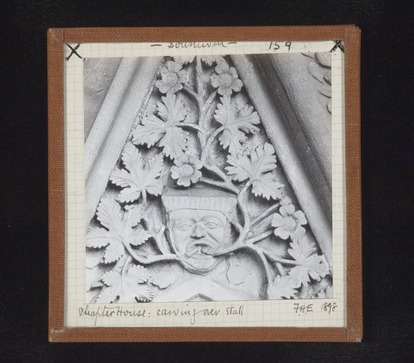 Detail view of canopy with foliate mask on tympanum in Chapter House, Southwell Minster, Southwell, Nottinghamshire, England