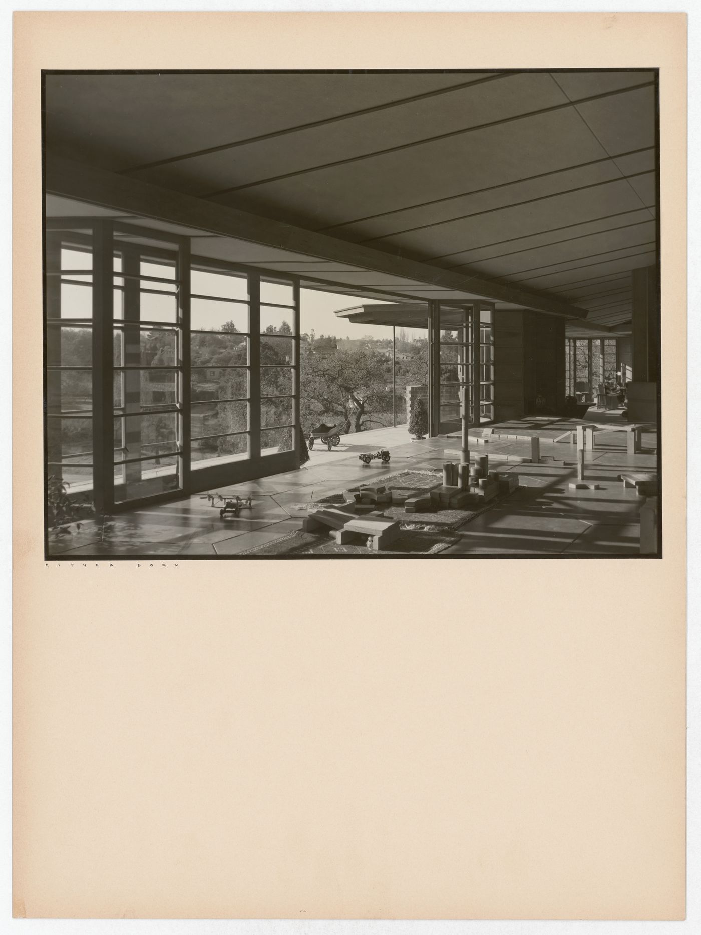 Interior view of the Hanna House showing windows, a doorway, toys, building blocks, and a wagon, Palo Alto, California, United States