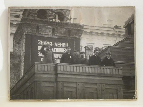Group portrait of six officials [?] standing on the tribunal adjacent to the second wooden Lenin Mausoleum during a May Day parade, Red Square, Moscow