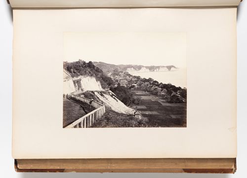View of Negishi Bay (also known as Mississippi Bay) and Honmoku Cape showing a road and houses along the shore, near Yokohama, Japan