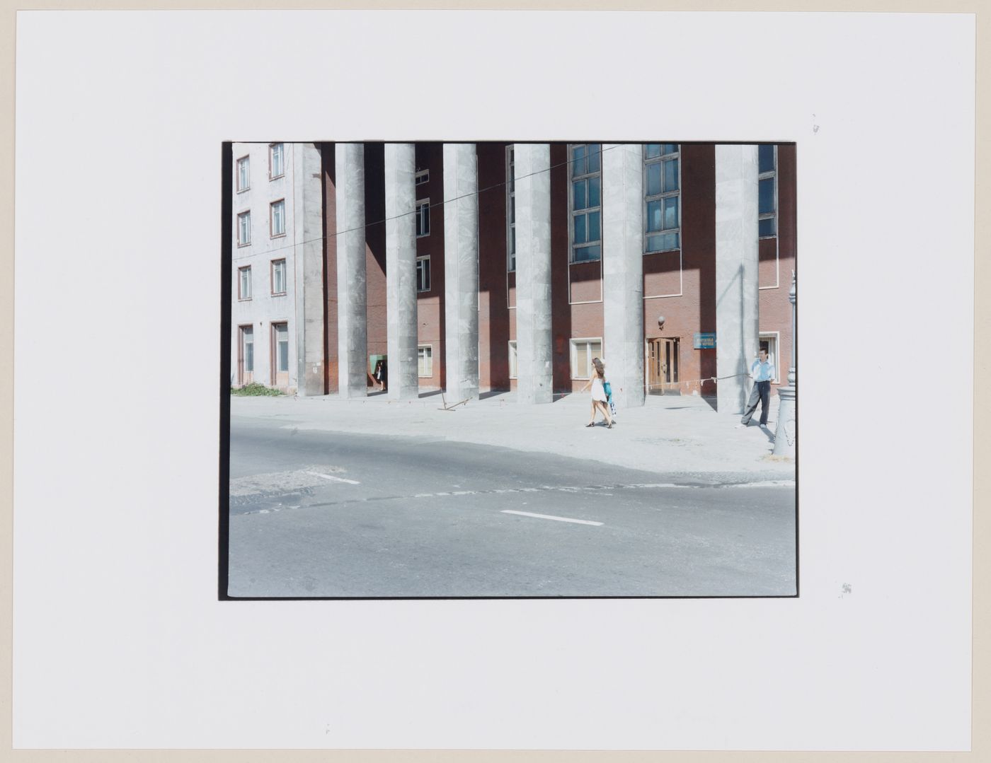 View of a portico showing columns, a street, and people, Kaliningrad, Kaliningradskaia oblast', Russia (from the series "In between cities")