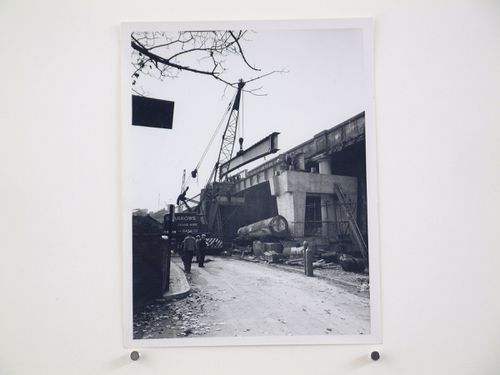 View of outer girder being lowered onto bearings by crane, Bushey Bridge, England