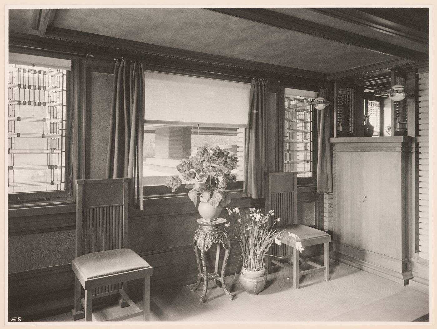 Interior view of Darwin D. Martin House showing the dining room looking out the stained glass windows designed by Orlando Giannini toward the east porch, Buffalo, New York