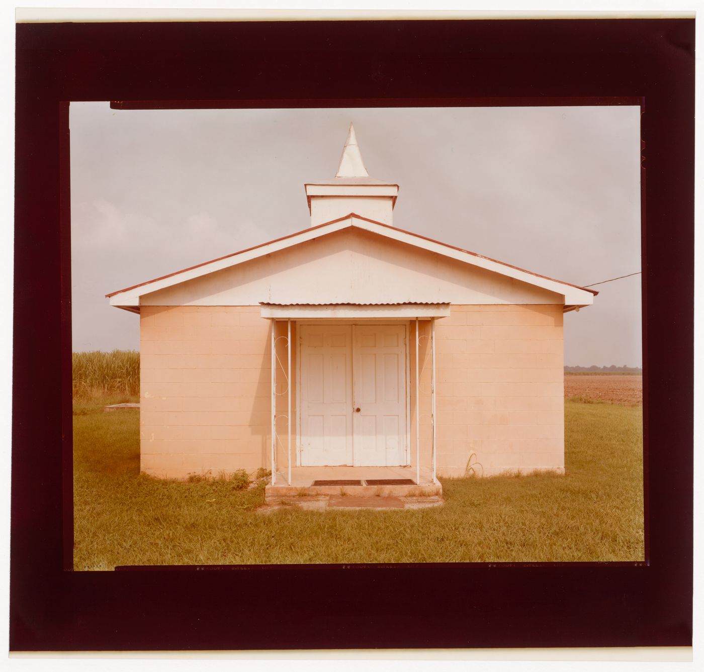 Cement block church in a cornfield. Napoleonville, Louisiana