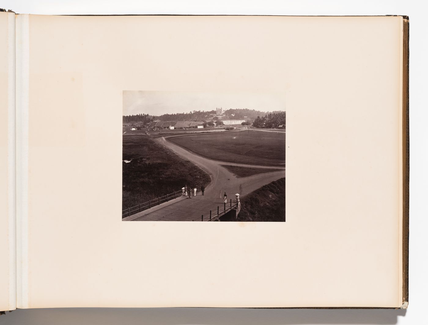 Distant view of houses [?] and St. Xavier College with people and a bridge in the foreground, Pointe de Galle (now Galle), Ceylon (now Sri Lanka)