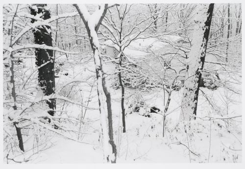 Suburban house covered with snow in woods, Hanover, New Hampshire