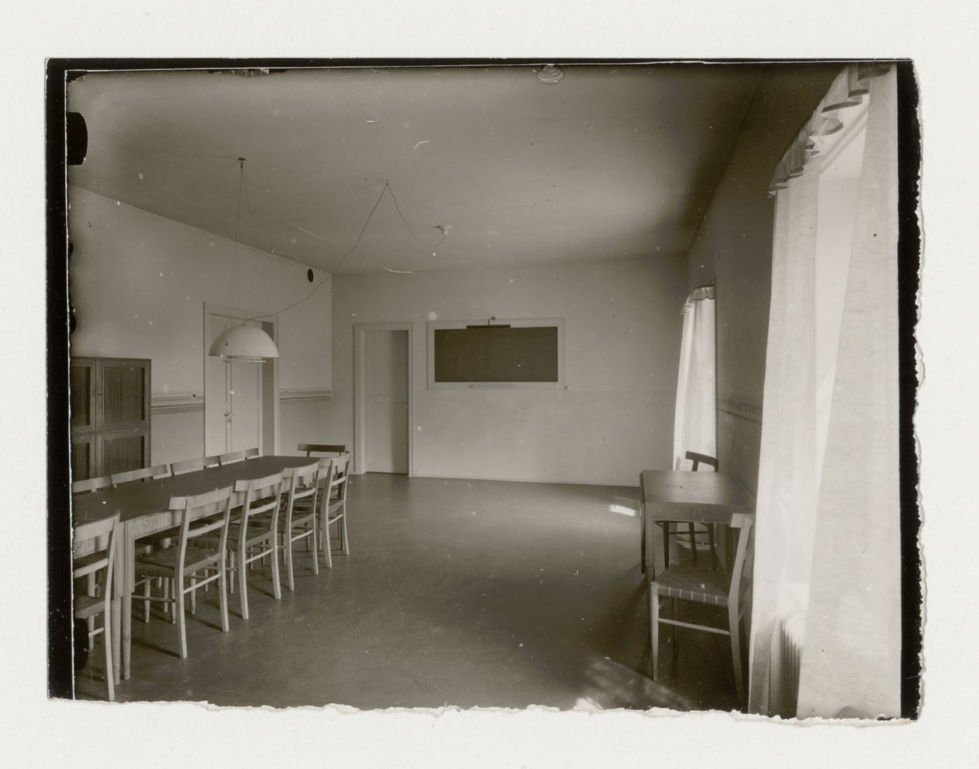 Interior view of the room for evening classes of Stockholm Public Library showing tables and chairs, 51-55 Odengatan, Stockholm