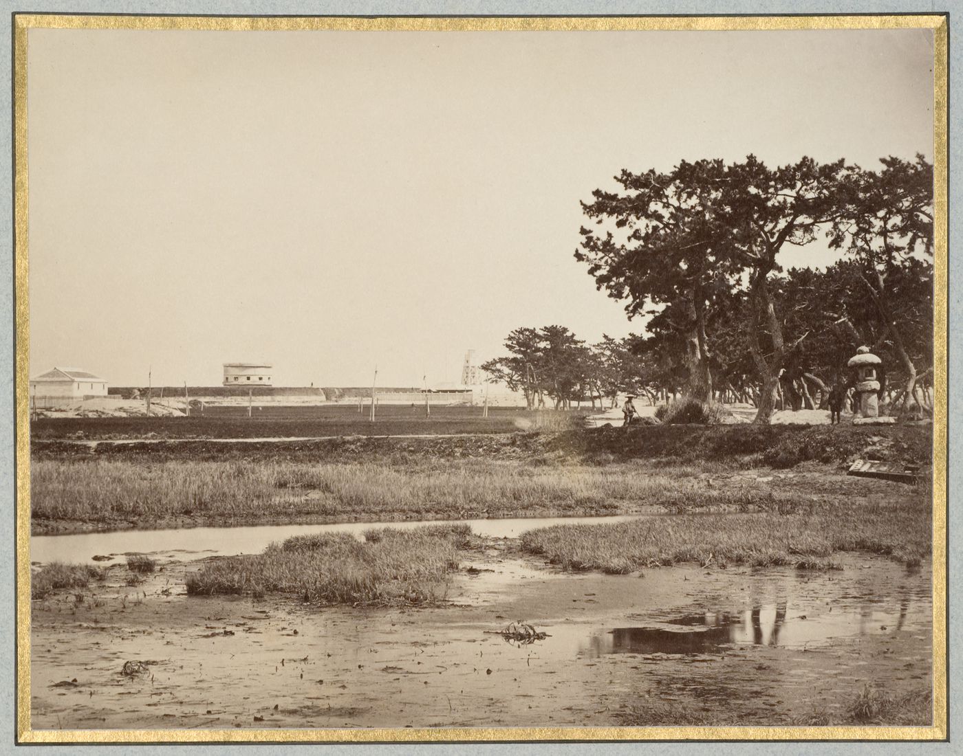 View of coastal fortifications showing a martello tower and a lighthouse, near Kobe, Japan