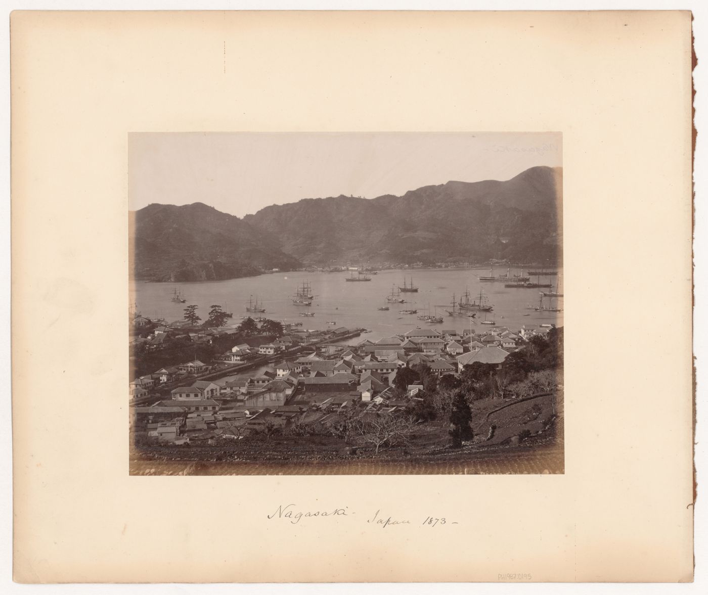 View of the harbour showing buildings at the waterfront and sailing vessels, Nagasaki, Japan