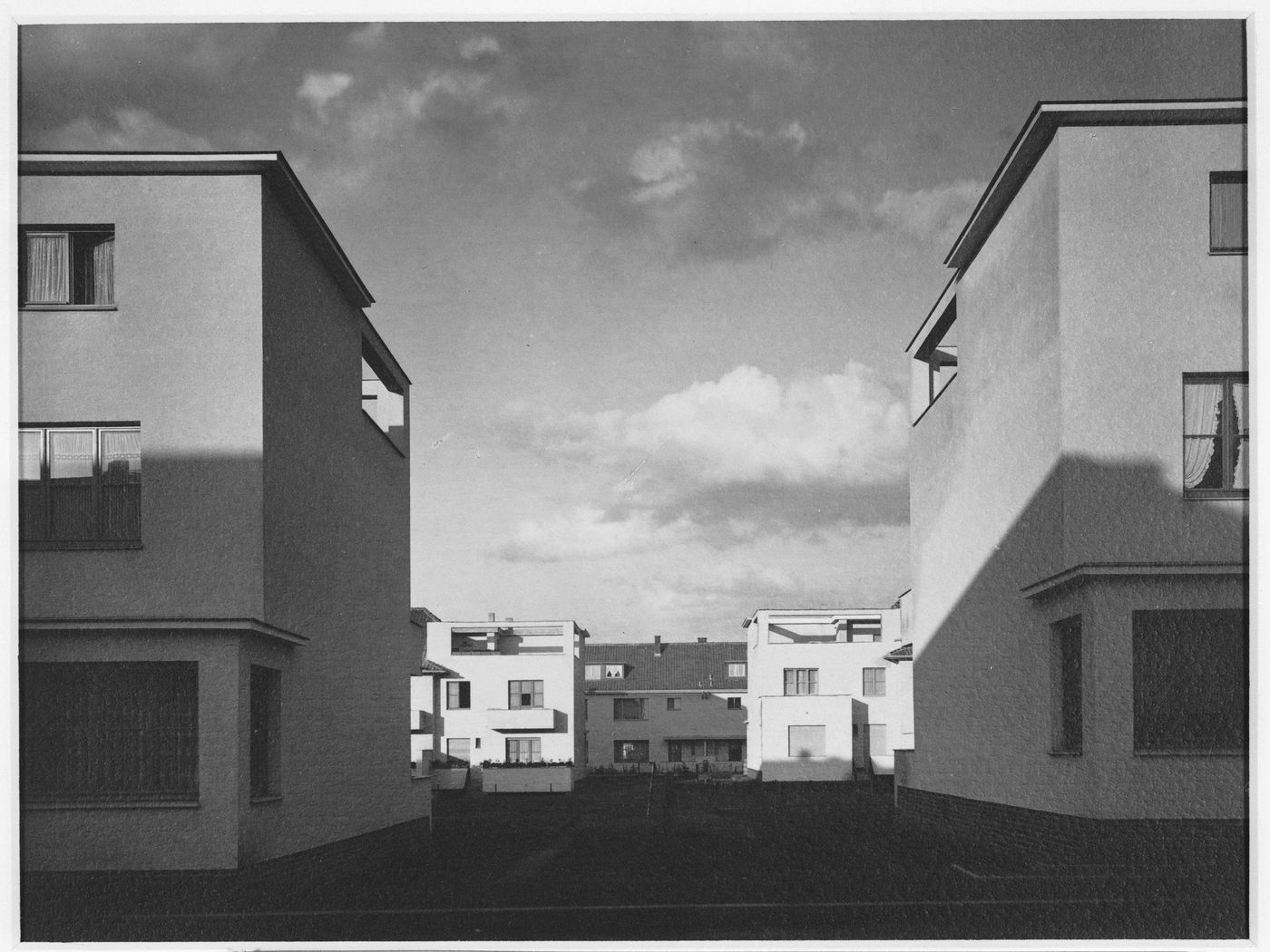 Exterior view of complex in housing development, framed between two ends of building rows, Kriel [?], Germany
