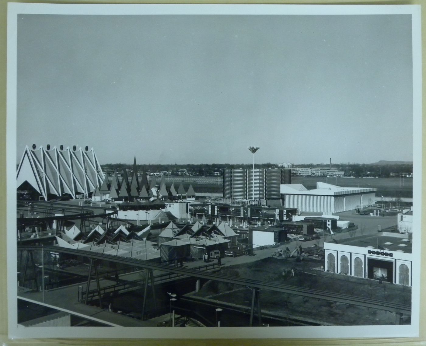 View of the Steel, Canadian Pulp and Paper, Canadian Pacific-Cominco and Arab Nations Pavilions with the minirail in foreground, Expo 67, Montréal, Québec