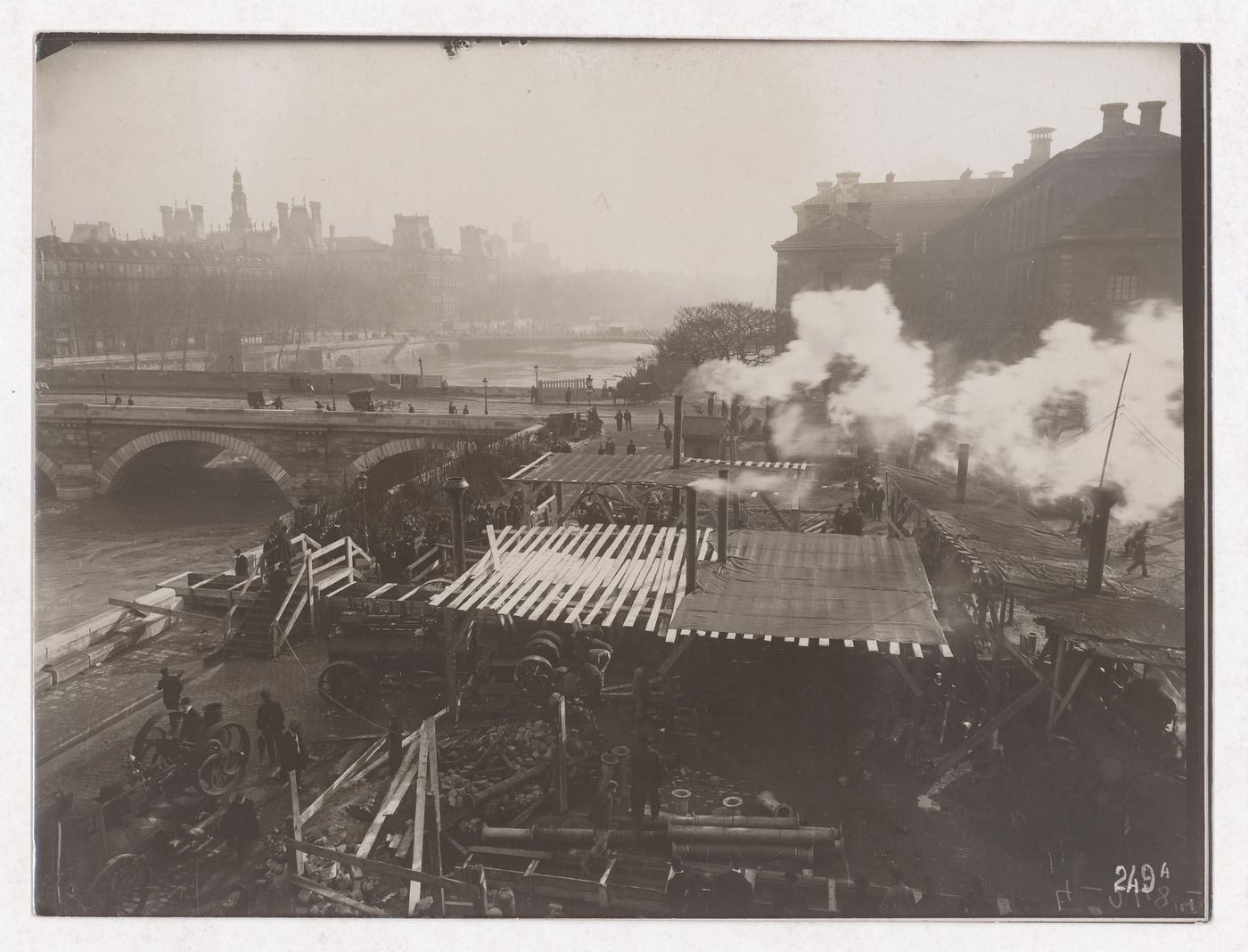 Construction of the Paris Metro, exterior view with machinery, workers and smoke coming out of smoke stacks, Paris, France