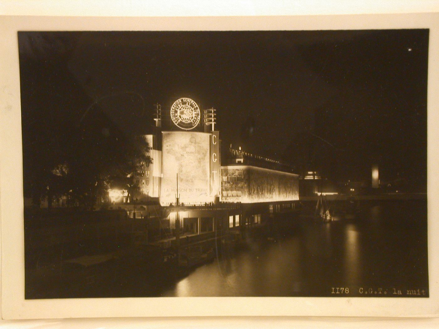 Night view of the Pavillon du Travail (also known as the Palais du Travail) with the Seine in the foreground, 1937 Exposition internationale, Paris, France