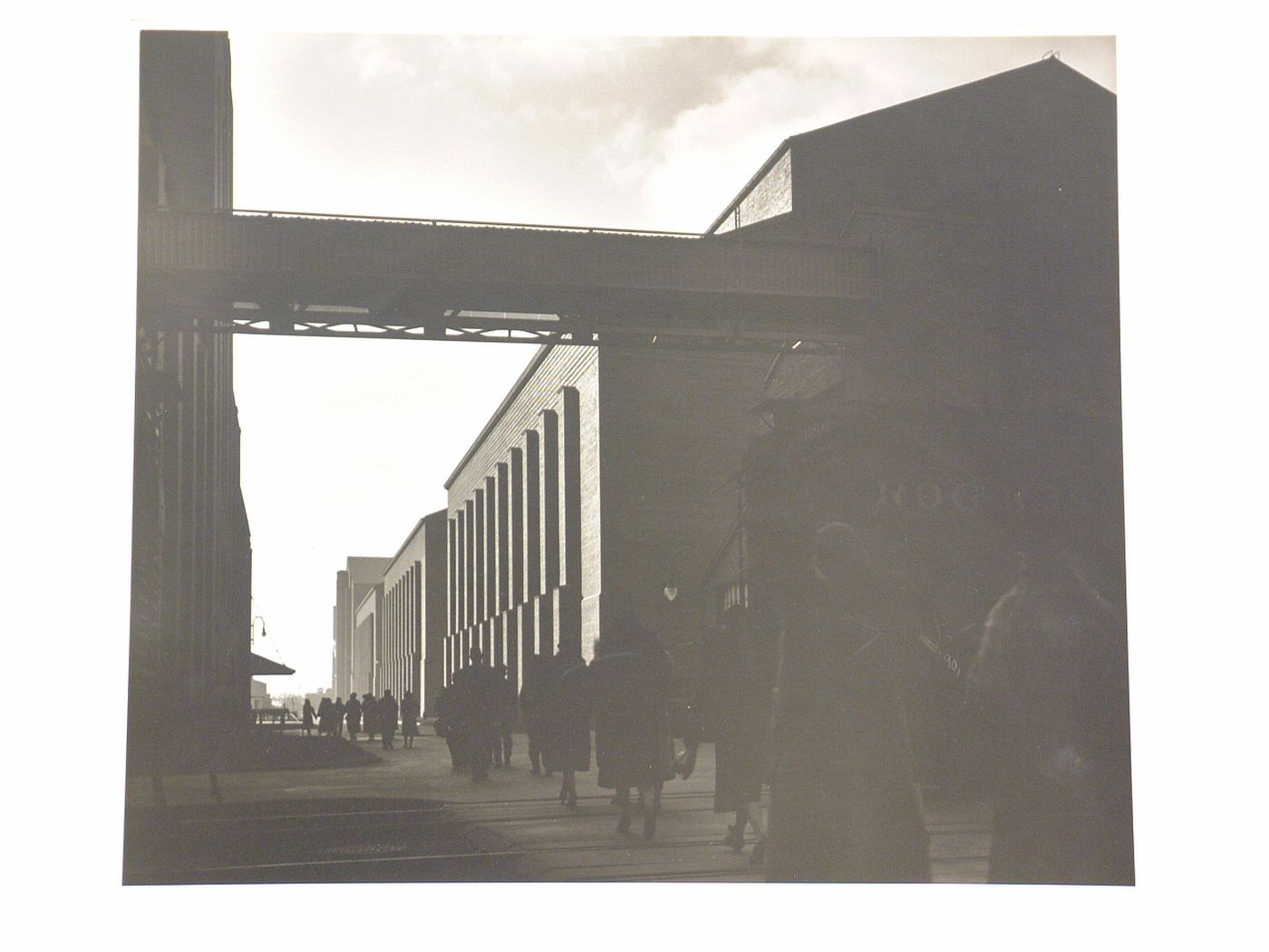 People walking by industrial factory building, Chicago, Illinois