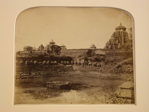 View of a dried-up water tank showing pavilions with the Lingaraj Temple complex in the background, Bhubaneswar, India