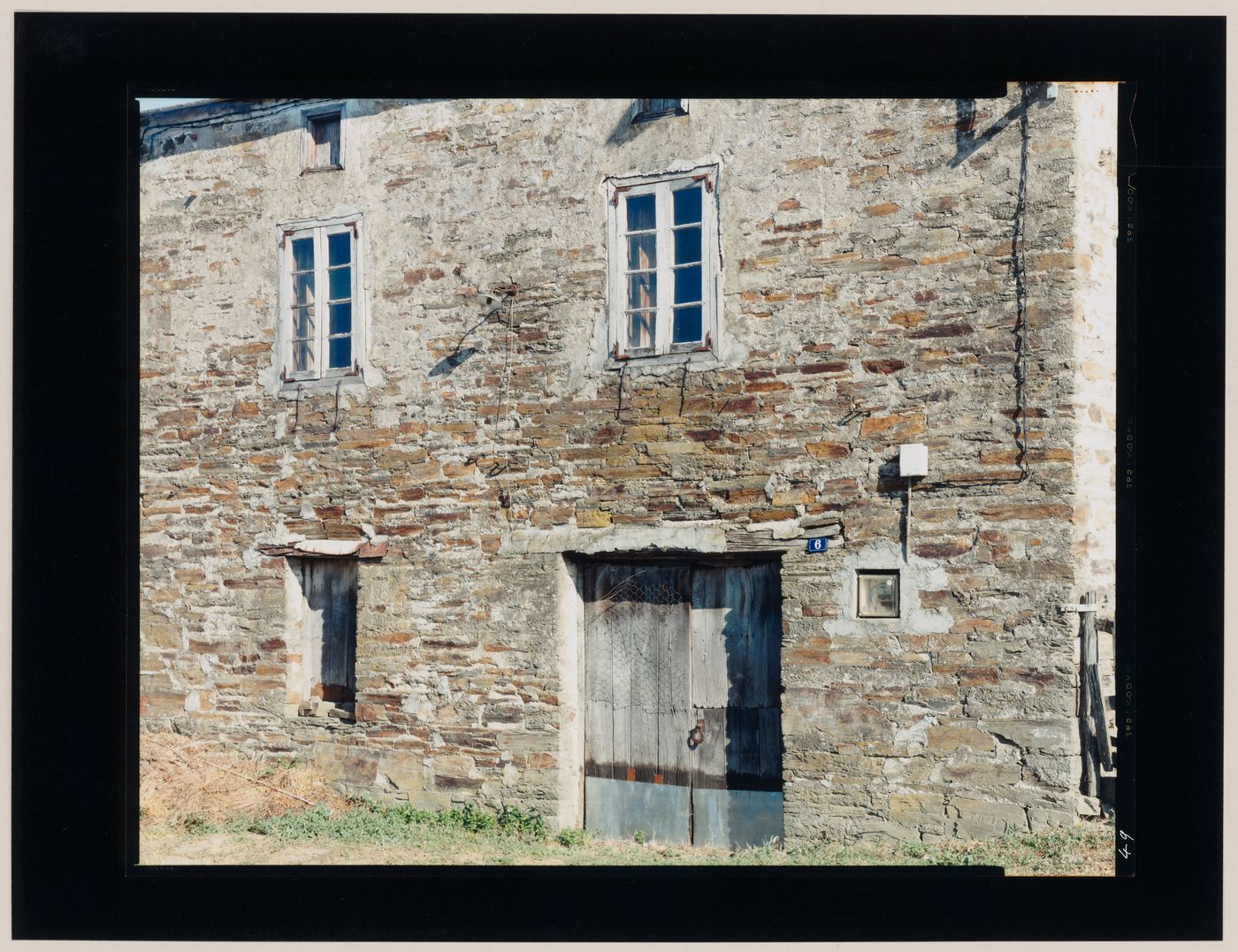 View of a stone house showing a door and windows, probably Castrotierra de Valmadrigal, León Province, Spain (from the series "In between cities")