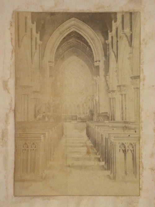 Interior view of a church looking up the central aisle of the nave towards the altar, England