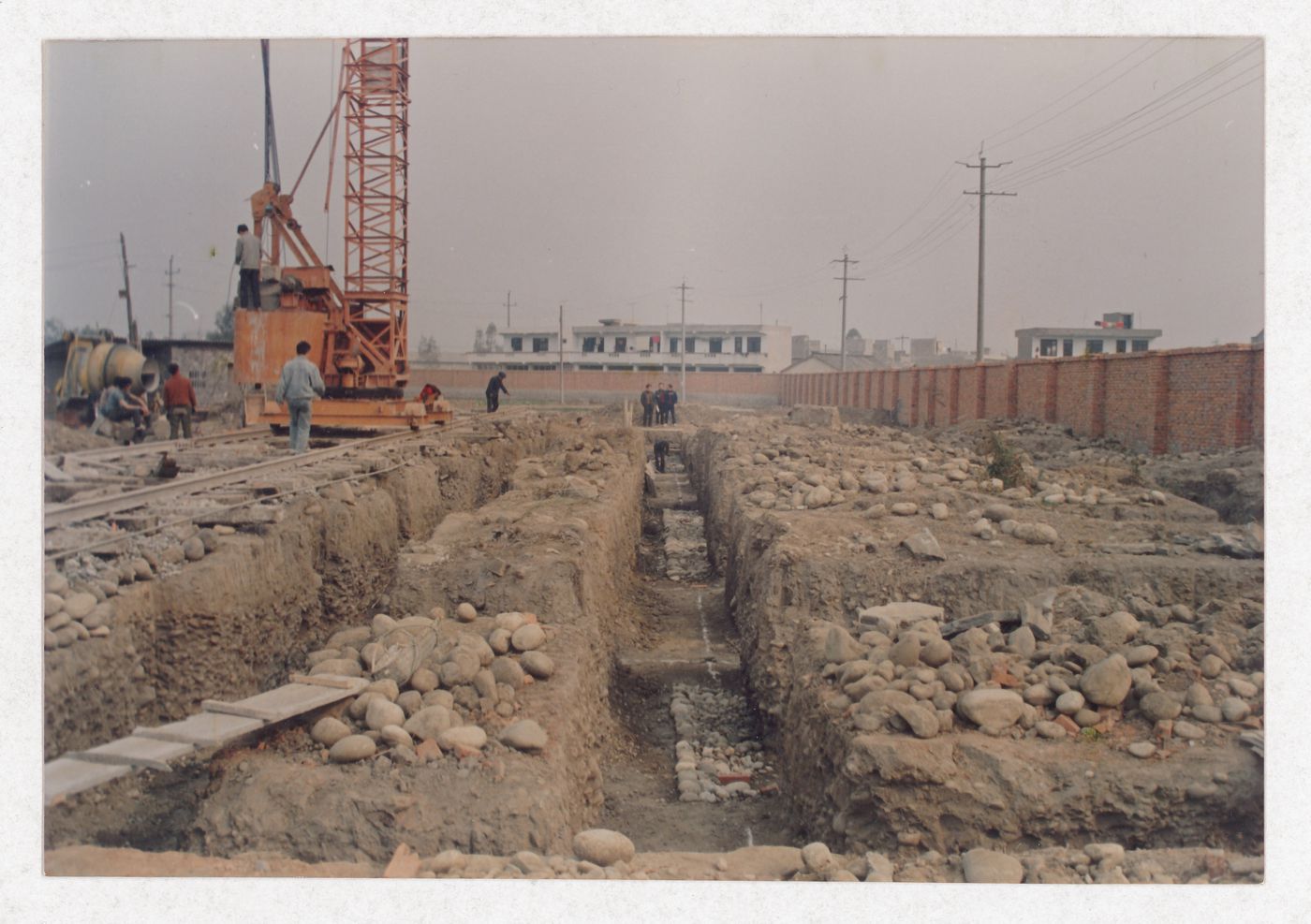 Workers on the site of housing under construction in China, possibly related to Sichuan housing project