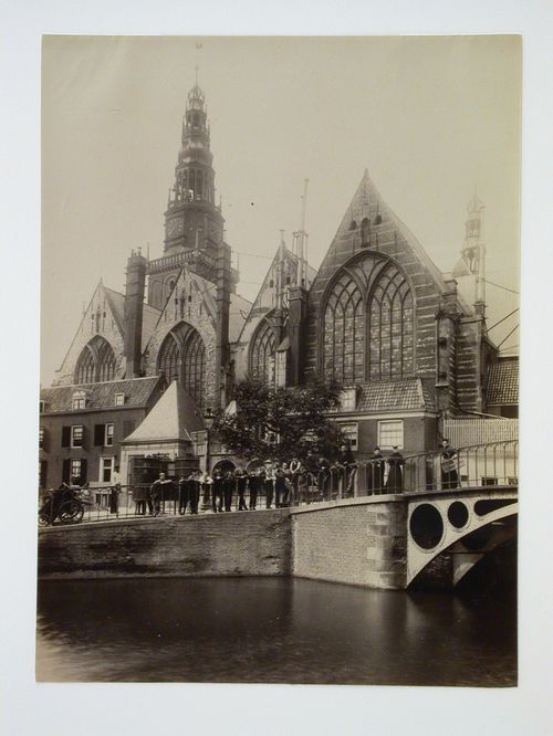 View across canal to large church, façade partically obscured by houses, Amsterdam [?], Netherlands