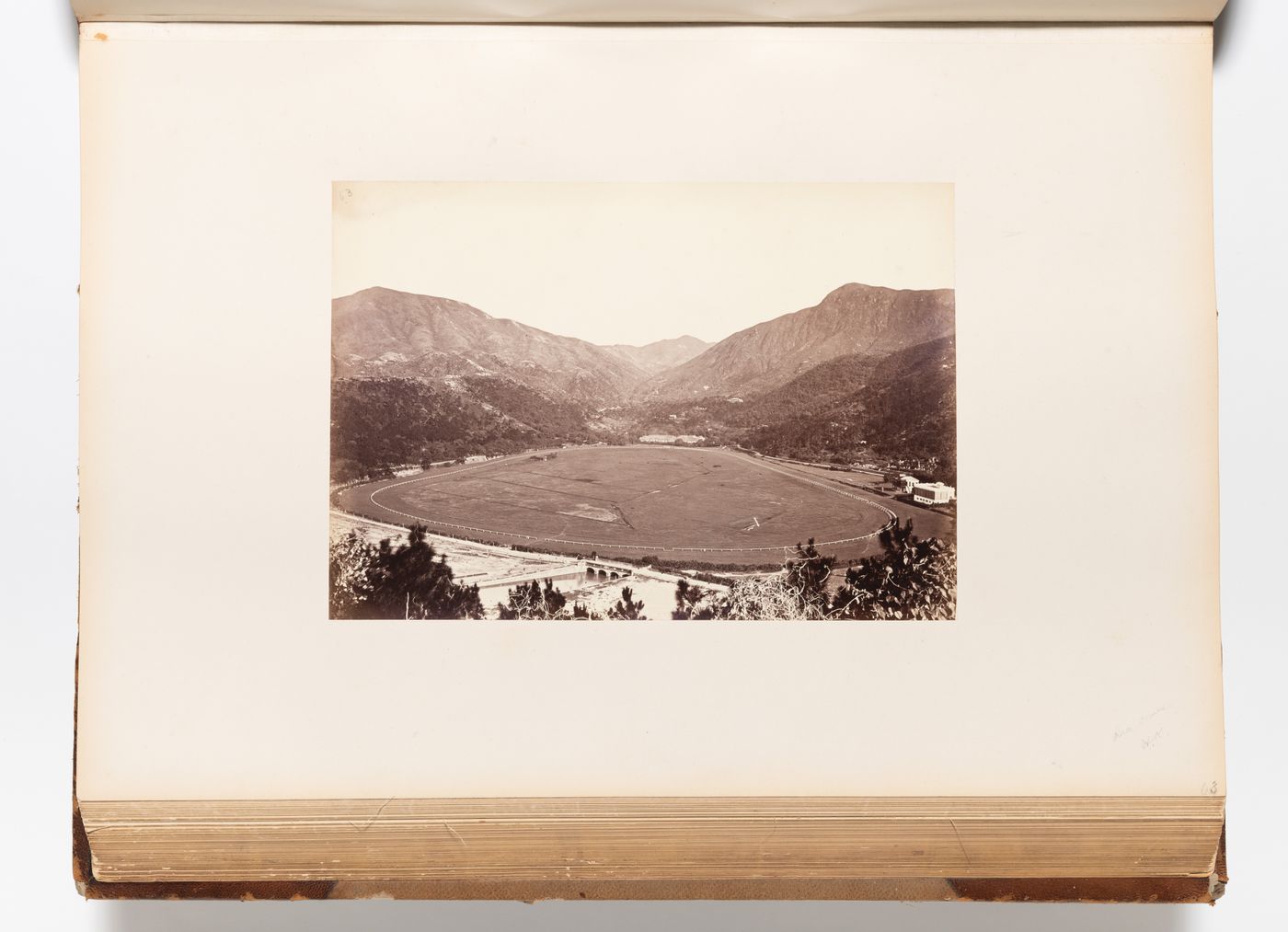 View of the Race Course at Happy Valley (also known as Wong Nei Chong Valley) showing the village of Wong Nei Chong in the background, Hong Kong (now Hong Kong, China)