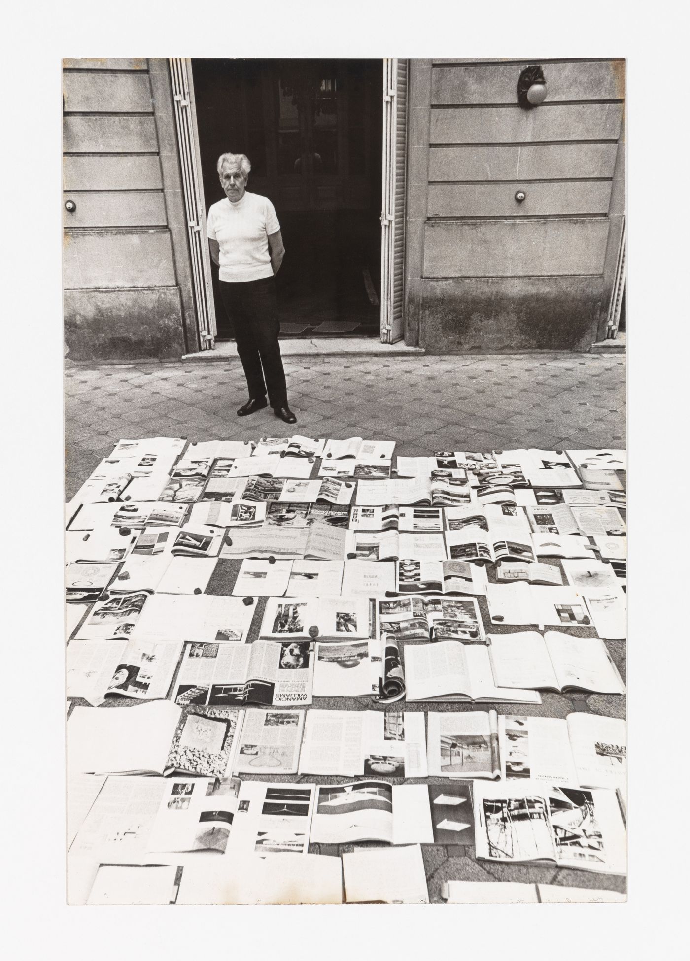 Photograph of Amancio Wiliams with publications featuring his work