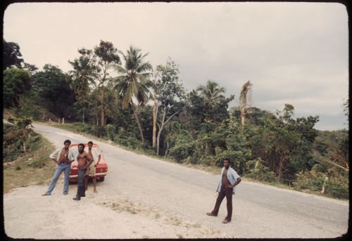 Men and parked car on the road, Jamaica