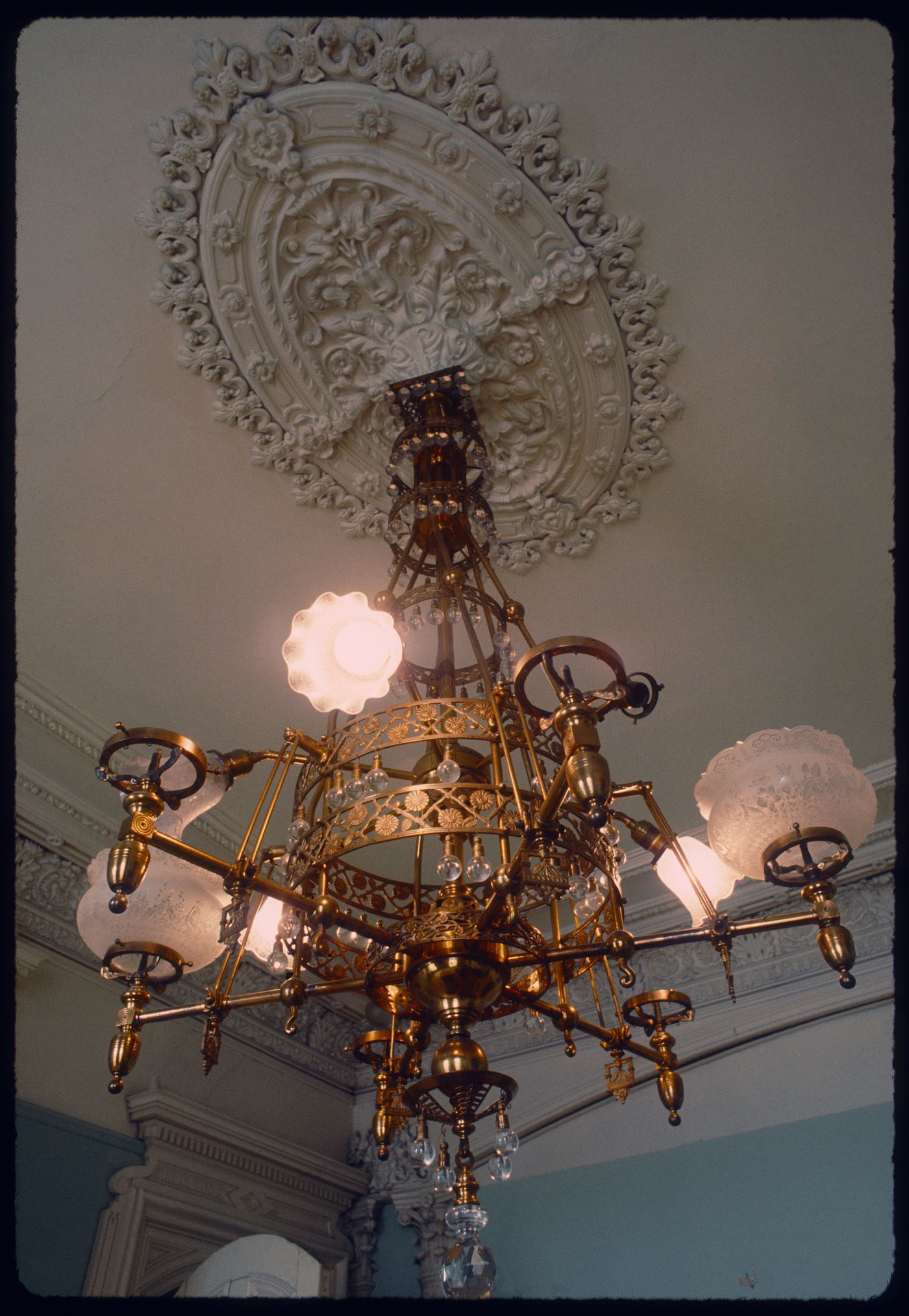 Interior view of a converted gas chandelier in a reception room of Shaughnessy House, Montréal, Québec