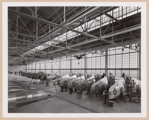 Interior view of the Assembly Building showing workers assembling airplanes, Curtiss-Wright Corporation Airplane division Assembly Plant, Buffalo, New York