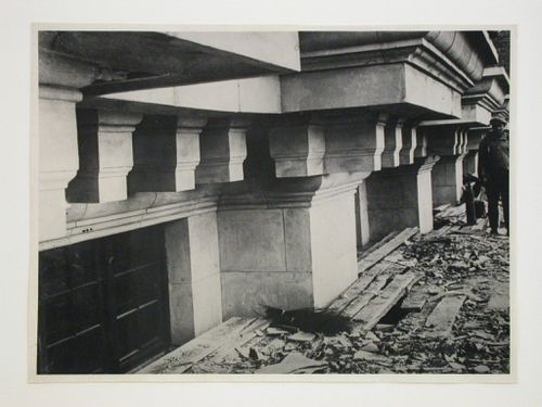 Close-up view of an apartment building under construction [?] with a worker in the background, 16 Mokhovaia Street, Moscow