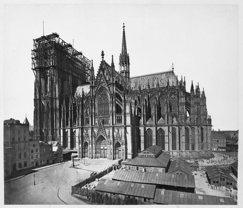 Exterior view of south flank of cathedral, showing construction work on west front towers, Cologne, Germany