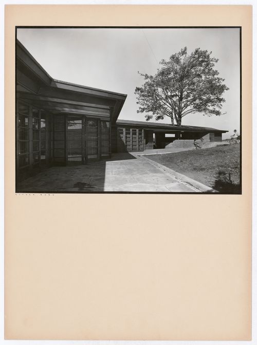 View of the Hanna House showing a terrace, entrances, a tree, and children playing, Palo Alto, California, United States