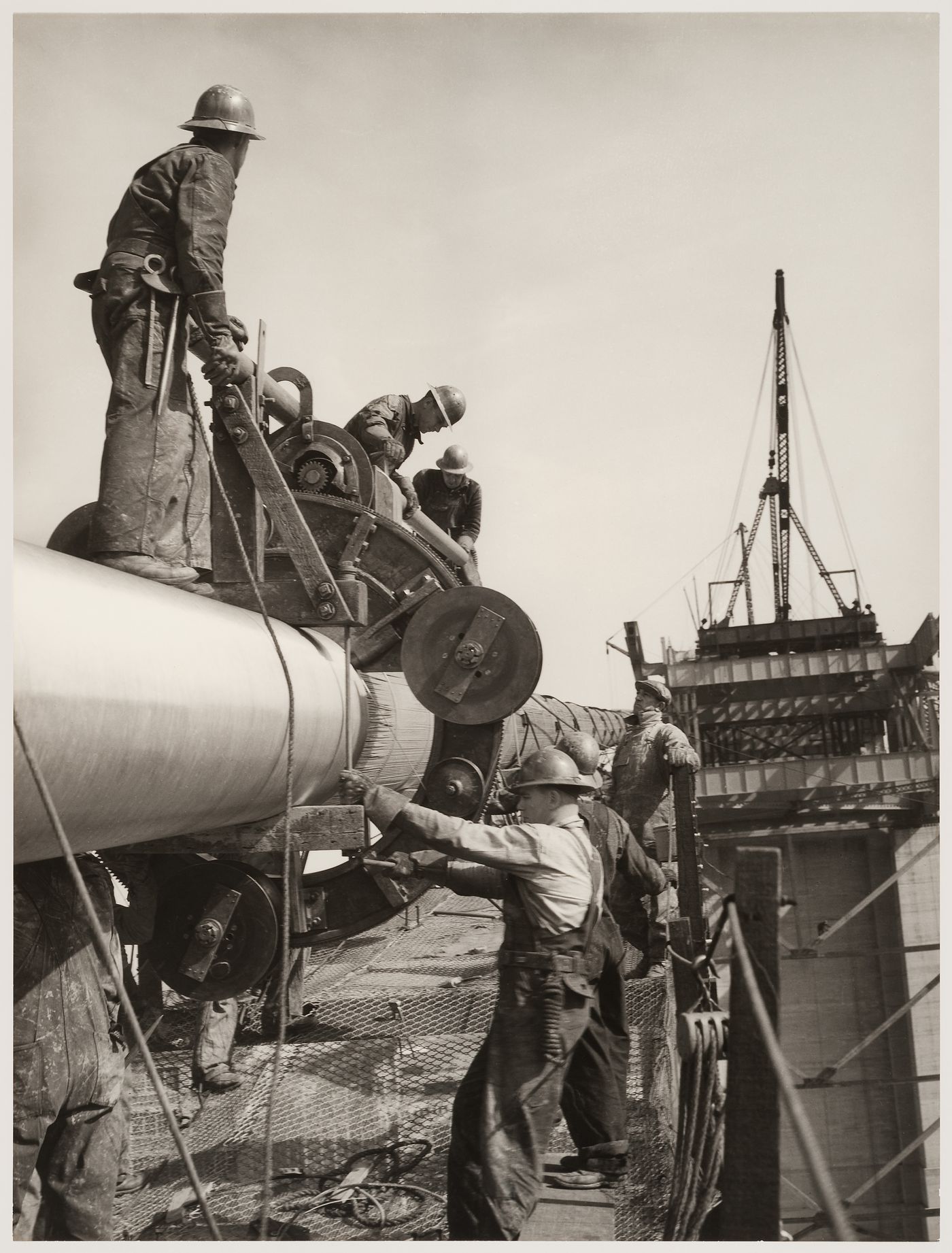 San Francisco - Oakland Bay Bridge under construction showing men working with steel tubing, San Francisco, California