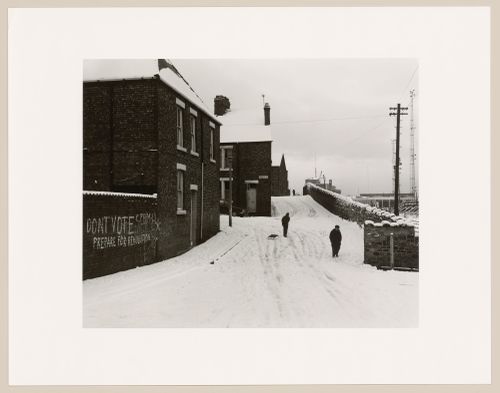 View of stone wall and brick row houses in the snow, Tyne and Wear, England