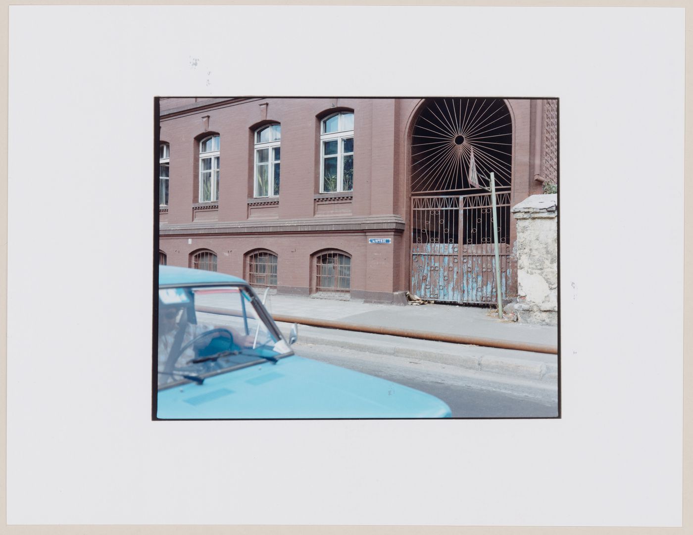 View of a building showing a gateway, a street, and an automobile, Kaliningrad, Kaliningradskaia oblast', Russia (from the series "In between cities")