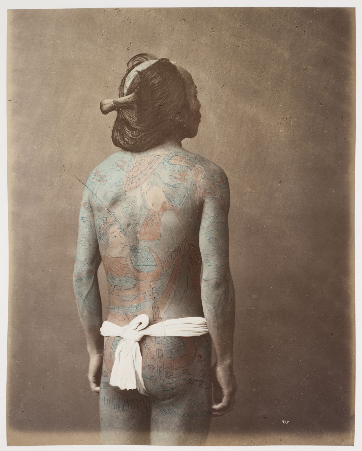 Portrait of a man showing tattoos on his back, Japan