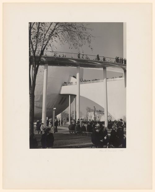 New York World's Fair (1939-1940): View from ground of Perisphere and connected Trylon, visitors walking and seated