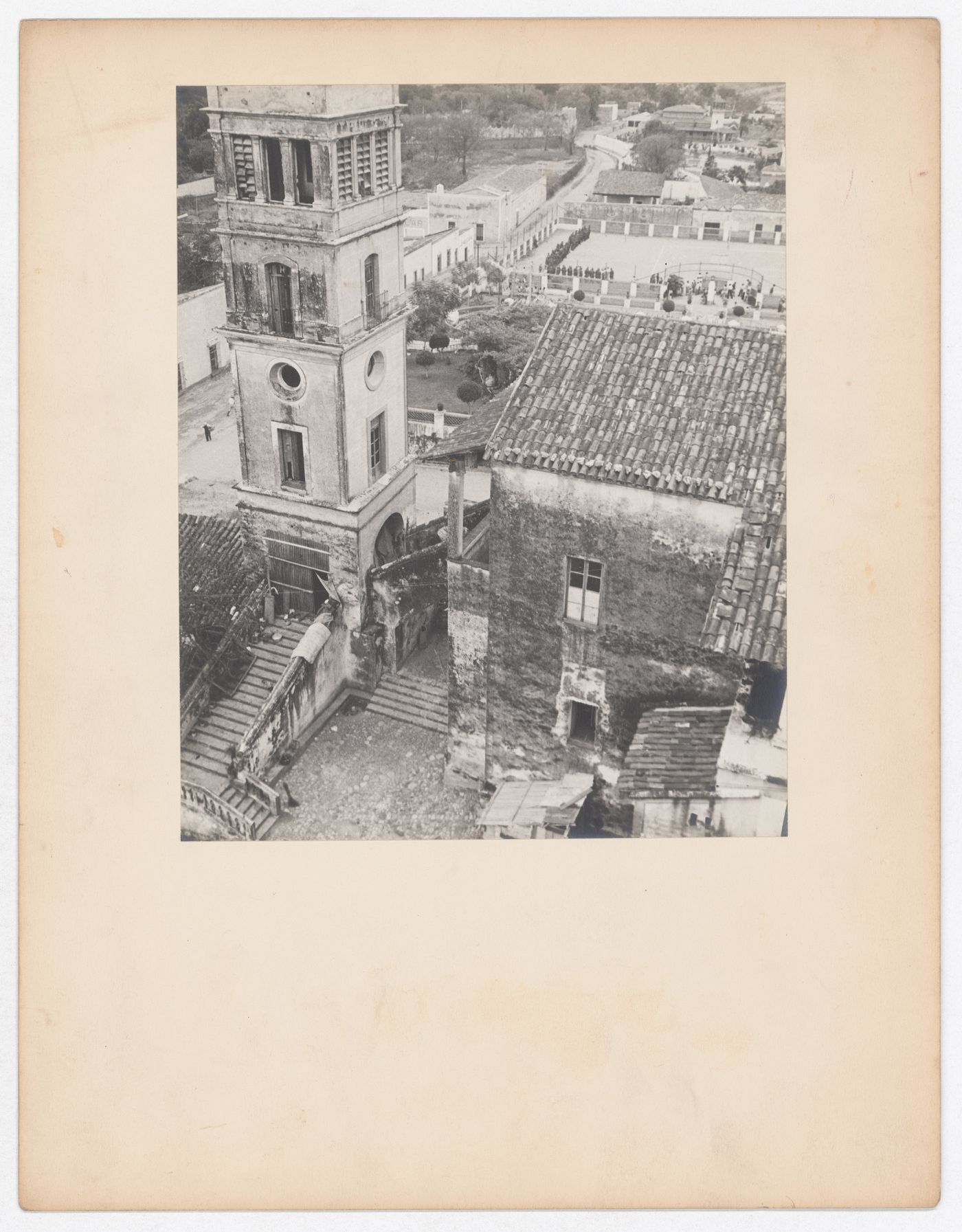 Partial view of a tower and house with an arena [?] and houses in the background, from the Catedral de Cuernavaca, Cuernavaca, Mexico