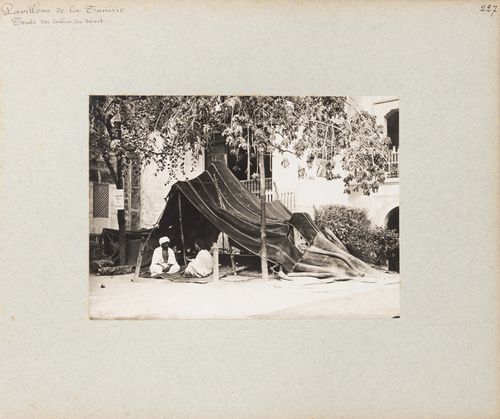 View of Bedouin tent with two men seated at entrance, Tunisian section, Exposition universelle, 1900, Paris, France
