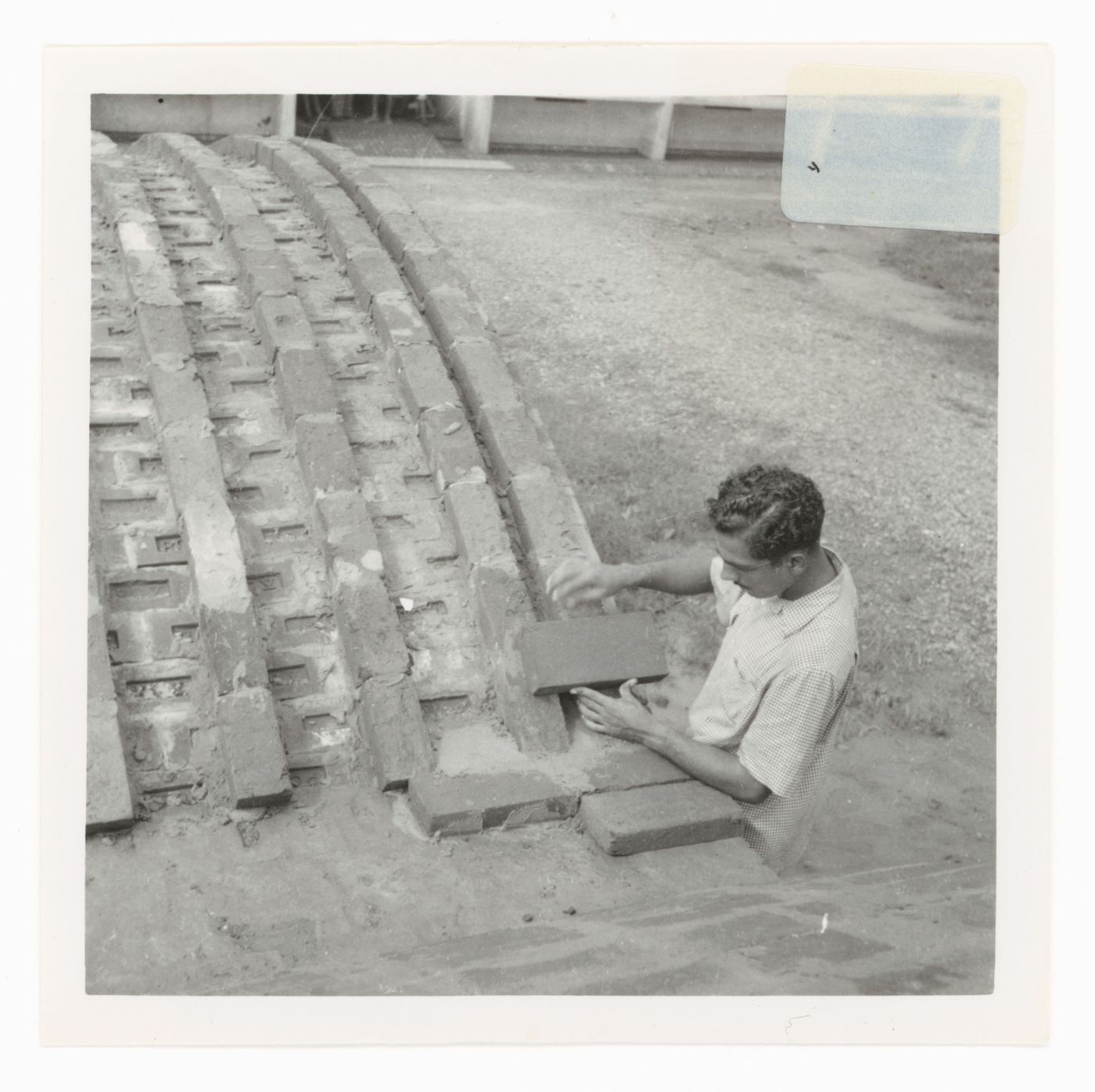 View of a construction worker laying bricks, possibly in Chandigarh, India