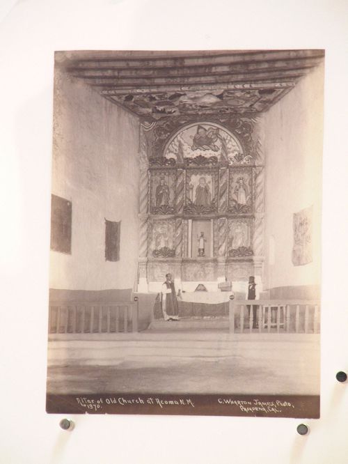 Interior view of the Old Acoma Church looking towards the altar and showing a priest and a man, Acoma, New Mexico, United States