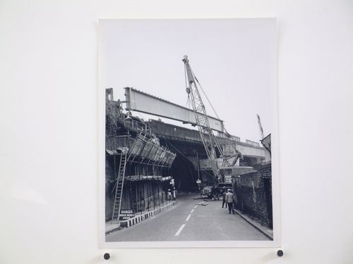 View of new outer girder being lifted from rail wagon being place in road, Bushey Bridge, England
