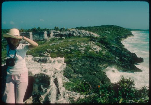Woman with camera in the ruins of Tulum, Mexico
