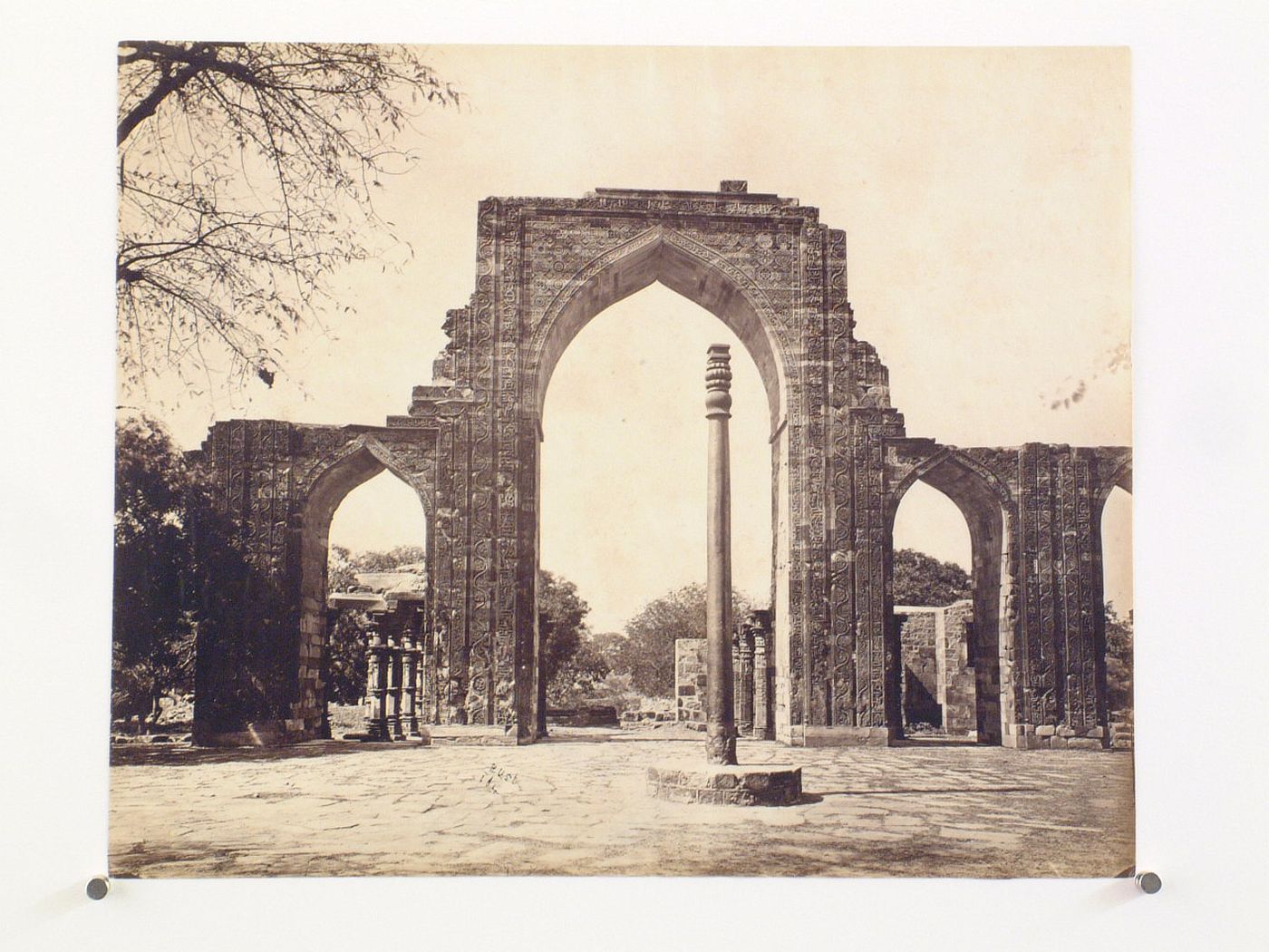 View of the arched screen façade of the Quwwat al-Islam [Might of Islam] Mosque and the Iron Pillar, Quwwat al-Islam Mosque Complex, Delhi, India