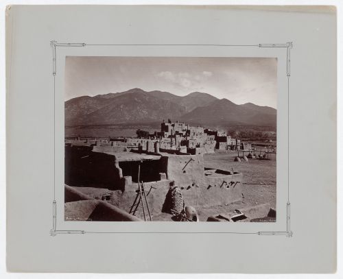 View of multi-storied houses on the north side of Taos Pueblo with Taos Mountains in the background, New Mexico, United States