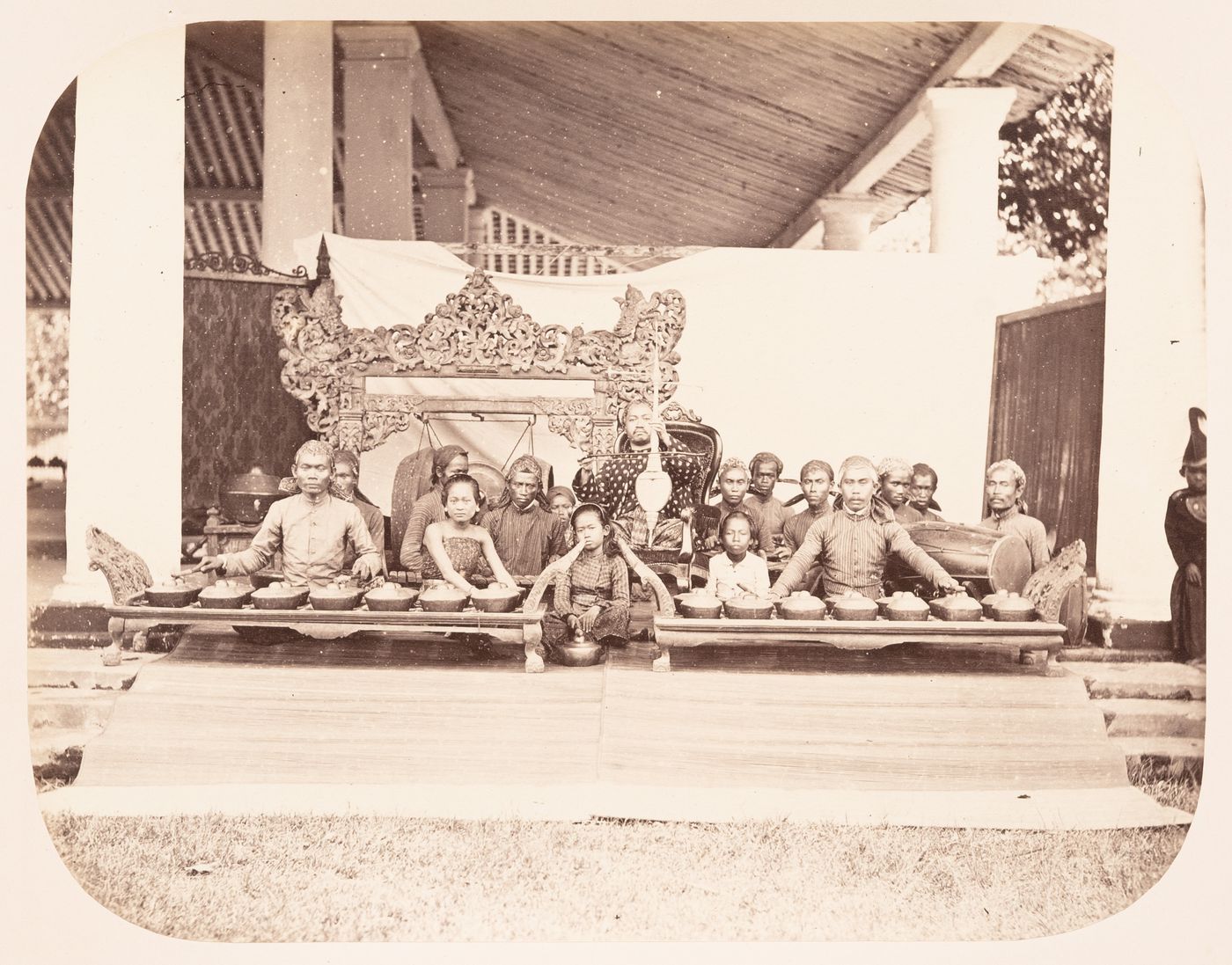 Group portrait of the musicians and instruments of a gamelan, probably in Bandong (now Bandung), Dutch East Indies (now Indonesia)