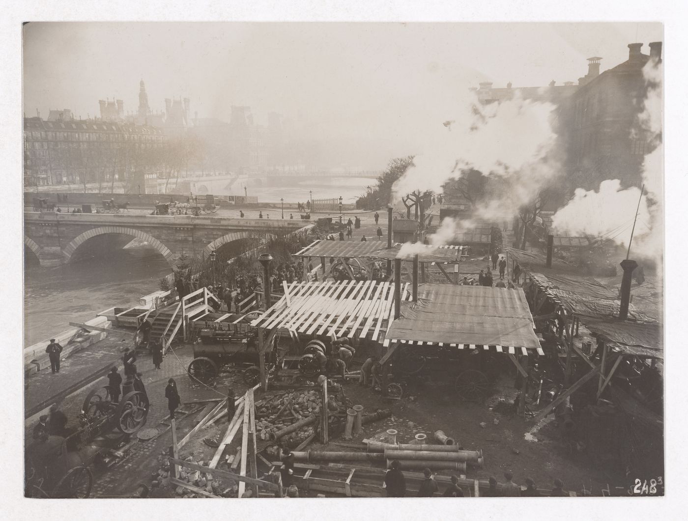 Construction of the Paris Metro, exterior view with machinery, workers and smoke coming out of smoke stacks, Paris, France