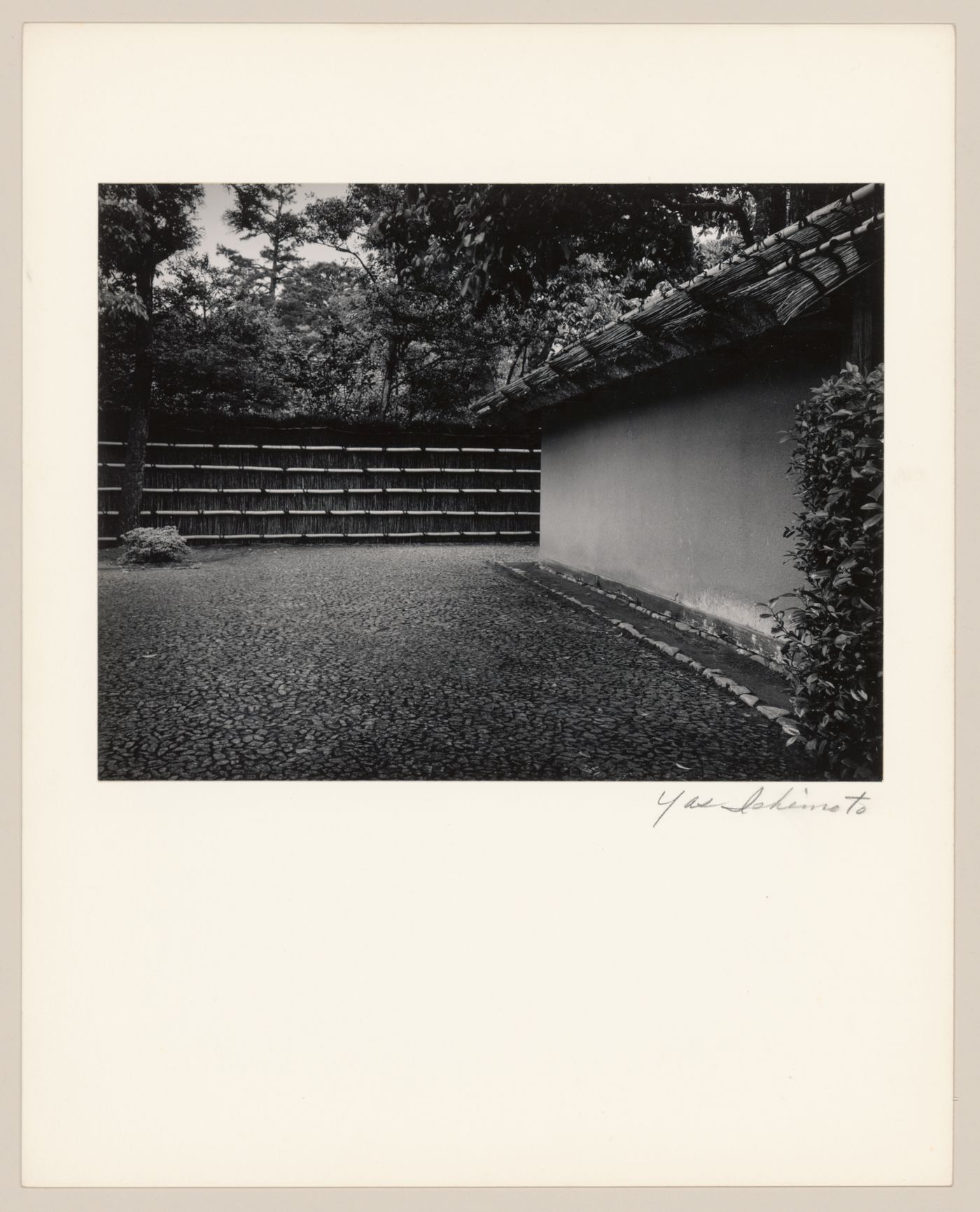 View of the paved courtyard and earthen wall near the Central Gate (also known as the Inner Gate), Katsura Rikyu (also known as Katsura Imperial Villa), Kyoto, Japan