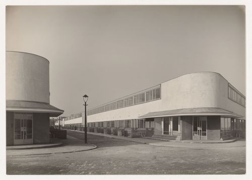 View of the principal façade of Kiefhoek Housing Estate showing a corner store from across the street, Rotterdam, Netherlands